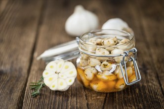 Fresh made Garlic (preserved) on a vintage background (close-up shot)