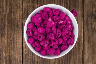Fresh made Raspberries (dried) on an old and rustic wooden table, selective focus, close-up shot