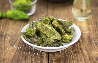 Pimientos de Padron on a vintage background as detailed close-up shot, selective focus