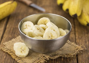 Sliced Bananas on a vintage background as detailed close-up shot, selective focus