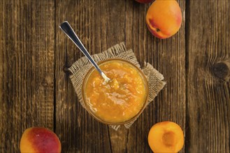 Fresh made Apricot Jam on a vintage background (close-up shot)