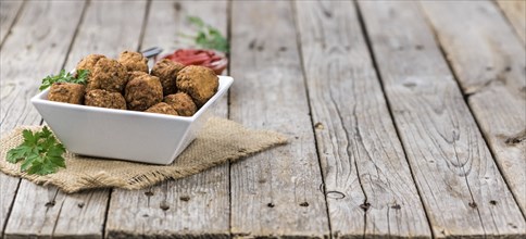 Some fresh made Meatballs on wooden background (selective focus, close-up shot)