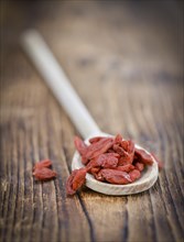 Fresh made Dried Goji Berries on a vintage background (close-up shot)