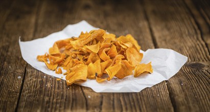 Homemade Sweet Potato Chips on vintage background selective focus, close-up shot