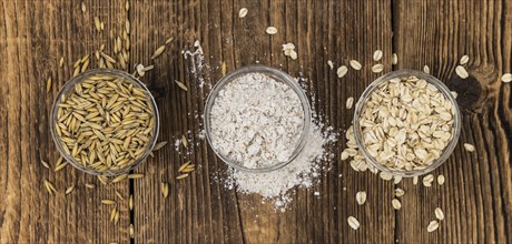 Some Oat Flour on a vintage wooden table (selective focus, close-up shot)