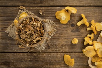 Dried Chanterelles on rustic wooden background as close-up shot