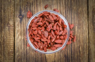 Fresh made Dried Goji Berries on a vintage background (close-up shot)