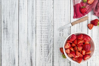 Fresh made Chopped Strawberries on a vintage background as detailed close-up shot