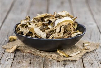 Dried Porcinis on an old wooden table as detailed close-up shot, selective focus