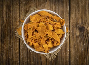 Homemade Sweet Potato Chips on vintage background selective focus, close-up shot