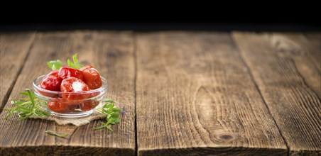 Fresh made Red Pepper (stuffed with cheese) on an old and rustic wooden table (selective focus,