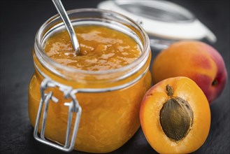 Fresh made Apricot Jam on a vintage background (close-up shot)