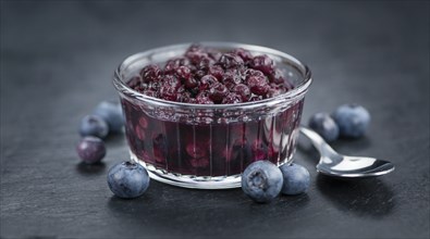 Some fresh Preserved Blueberries on a vintage slate slab, selective focus, close-up shot