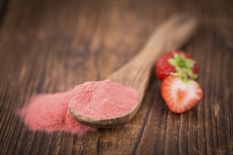 Fresh made Strawberry powder on a vintage background as detailed close-up shot