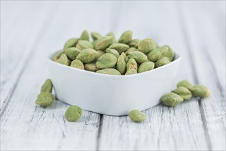 Wasabi Peanuts on a vintage background as detailed close-up shot (selective focus)