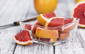 Grapefruits slices (selective focus) on a vintage background as detailed close-up shot