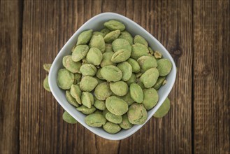 Wasabi Peanuts on a vintage background as detailed close-up shot (selective focus)