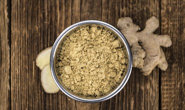 Portion of healthy Ground Ginger on an old wooden table (selective focus, close-up shot)