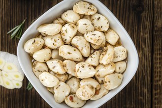 Fresh made Garlic (preserved) on a vintage background (close-up shot)