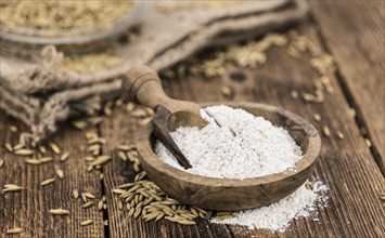 Some Oat Flour on a vintage wooden table (selective focus, close-up shot)