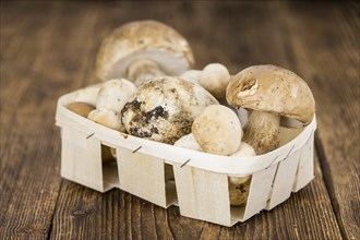 Fresh Porcinis on an old wooden table (close-up shot, selective focus)