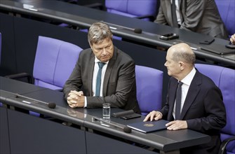 Federal Chancellor Olaf Scholz speaks with Federal Economics Minister Robert Habeck in front of the