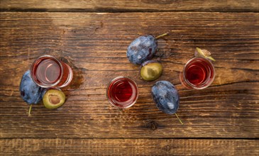 Fresh made Plum Liqueur on a vintage background as detailed close-up shot