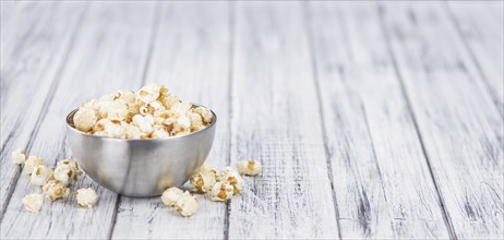 Fresh made Popcorn on an old and rustic wooden table, selective focus, close-up shot