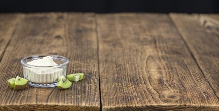 Kiwi ground (detailed close-up shot) on a vintage wooden background