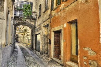 Beautiful and Old Colorful Stone Narrow Street Alley with an Arch in Orta, Piedmont, Italy, Europe