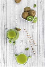 Kiwi Smoothie (selective focus) on an old and vintage background (homemade)