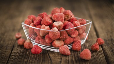 Dried Strawberries on rustic wooden background as close-up shot