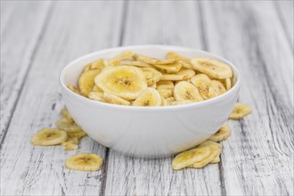 Portion of fresh Dried Banana Chips close-up shot, selective focus