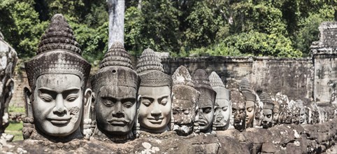 Heads of demons at the entrance to the southern gate of Angkor Thom in Cambodia