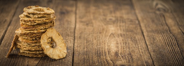 Dried Pineapple Rings on a vintage background as detailed close-up shot, selective focus