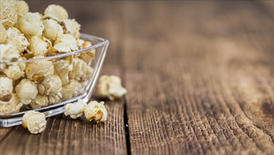 Fresh made Popcorn on a vintage background as detailed close-up shot