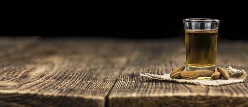 Amaretto on an old wooden table (selective focus)