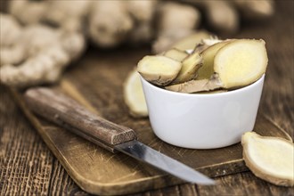 Healthy Raw Ginger on a wooden table as detailed close-up shot (selective focus)
