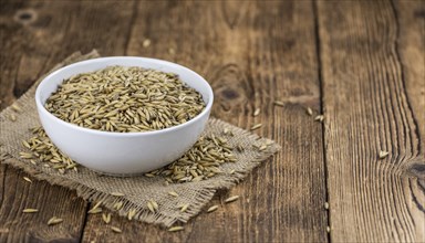 Wooden table with Oat (detailed close-up shot, selective focus)