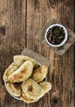 Portion of fresh homemade Empanadas as detailed close-up shot, selective focus