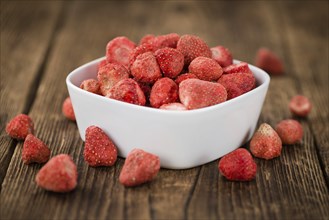 Dried Strawberries on rustic wooden background as close-up shot