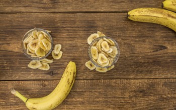 Dried Banana Chips on a vintage background as detailed close-up shot, selective focus