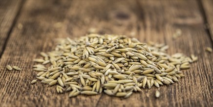 Wooden table with Oat (detailed close-up shot, selective focus)