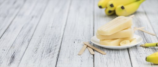 Banana Popsicles on a vintage background (close-up shot, selective focus)