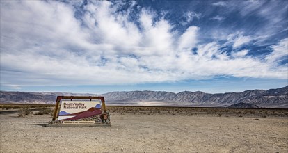 Death Valley National Park sign with cloudy sky