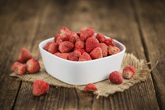 Dried Strawberries on rustic wooden background as close-up shot