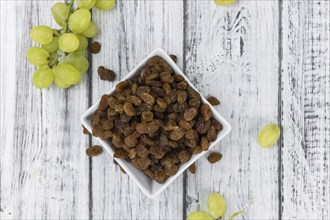 Wooden table with Raisins (detailed close-up shot, selective focus)