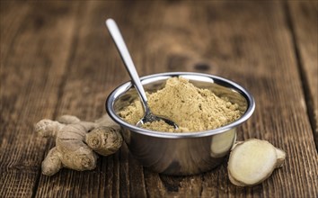 Portion of healthy Ground Ginger on an old wooden table (selective focus, close-up shot)