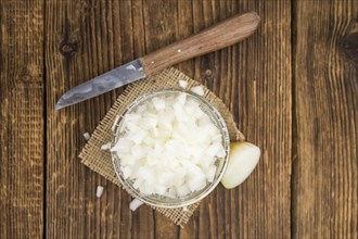 Diced white onions on a vintage background as detailed close-up shot, selective focus