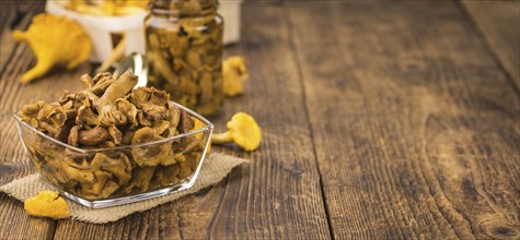 Canned chanterelles on a vintage background as detailed close-up shot, selective focus